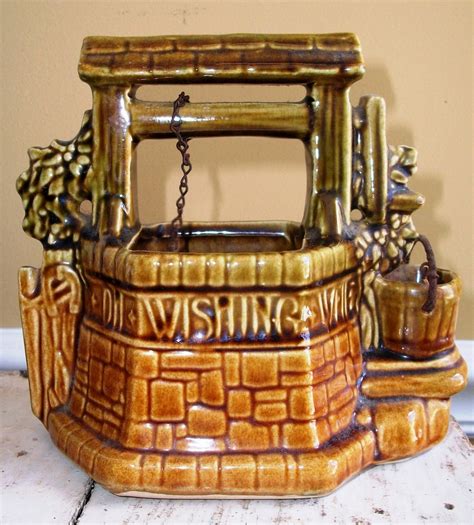 Mccoy wishing well - This sweet vintage McCoy wishing well planter is so retro and fun! Made of sturdy ceramic with a rich, golden caramel and brown glaze, this little wishing well is ready to make your wishes come true. Great details, from the little metal handle on the bucket to the words around the rim, which read: